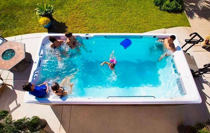 family playing in swim spa 