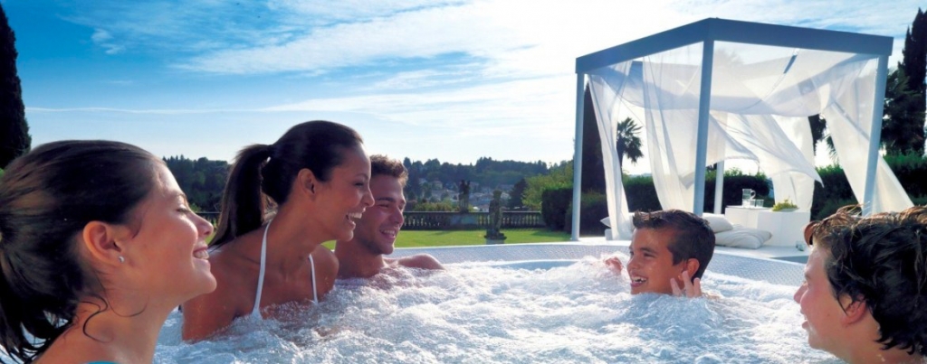 family in swim spa hot tub having fun