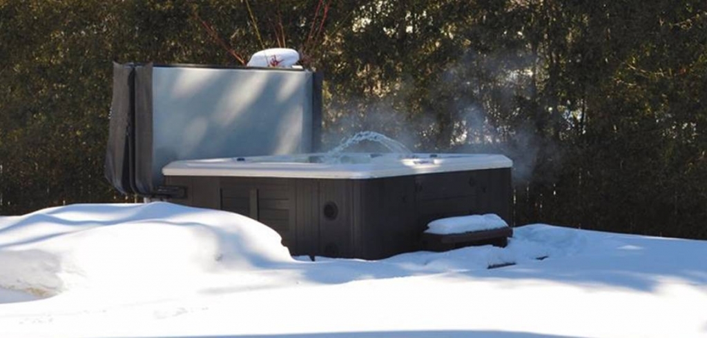 hot tub winter scene with snow on ground