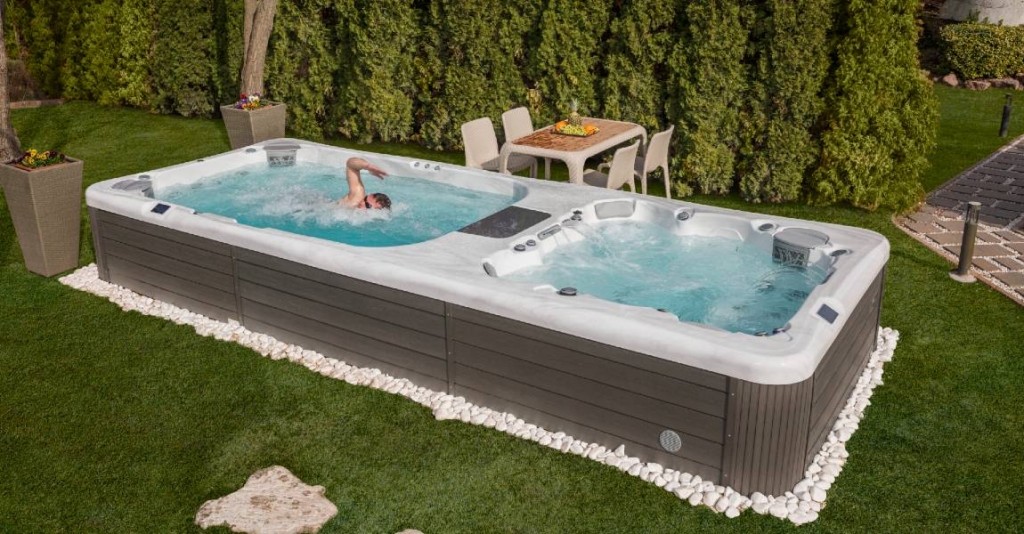 man swimming in swim spa hot tub combo