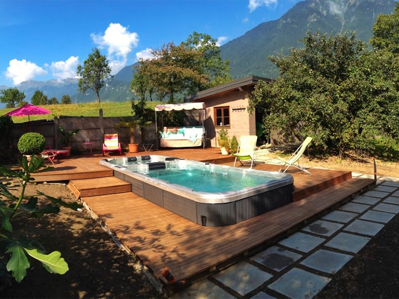 swim spa in wood deck mountain background